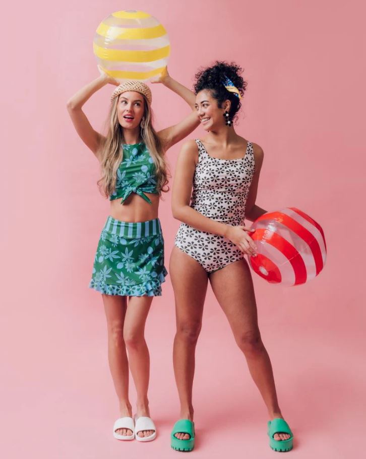 two women modeling modest swimwear in floral two-piece matching sets