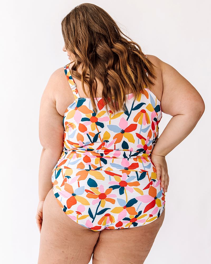 Photo of a woman wearing a June floral square neck swim top and a June floral swim bottom back angle