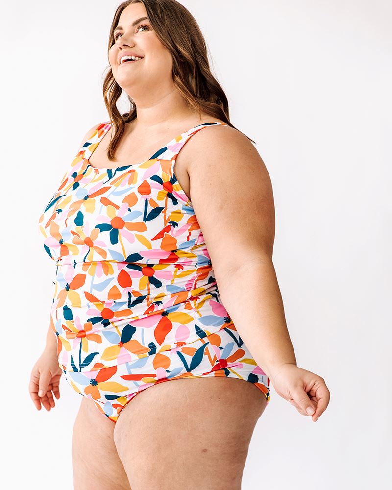 Photo of a woman wearing a June floral square neck swim top and a June floral swim bottom side angle